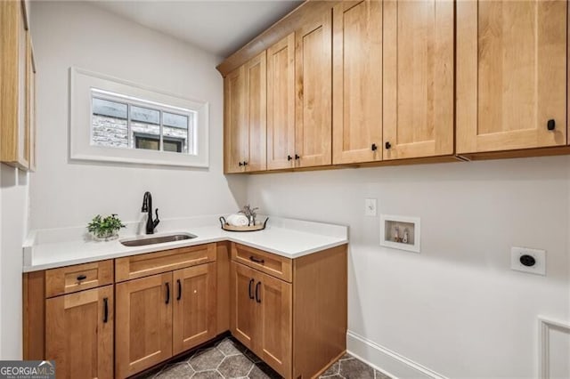 clothes washing area with electric dryer hookup, cabinets, sink, and washer hookup