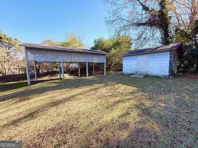 view of yard with a carport and a shed