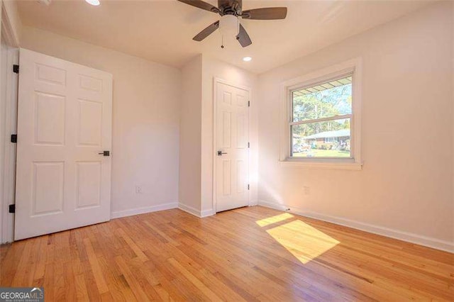 unfurnished bedroom featuring light hardwood / wood-style flooring and ceiling fan