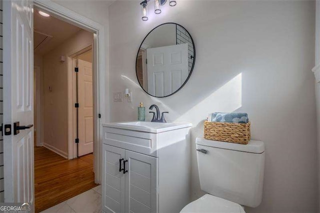 bathroom featuring tile patterned flooring, vanity, and toilet