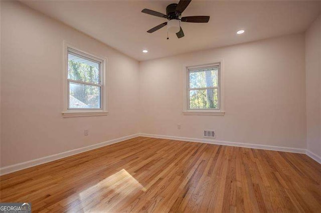 spare room with light wood-type flooring and ceiling fan