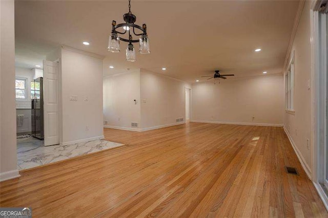 interior space featuring light hardwood / wood-style flooring, ceiling fan, and ornamental molding