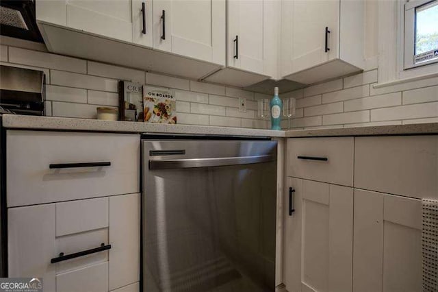 kitchen with dishwasher, white cabinetry, and backsplash