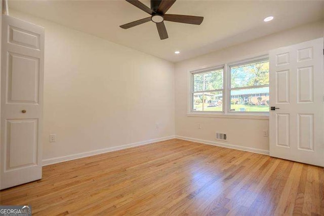 spare room with ceiling fan and light hardwood / wood-style floors