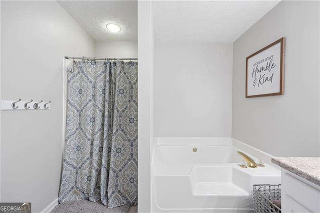 bathroom with vanity, separate shower and tub, and a textured ceiling