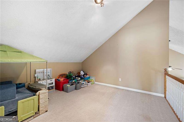 additional living space featuring a textured ceiling, light carpet, and lofted ceiling