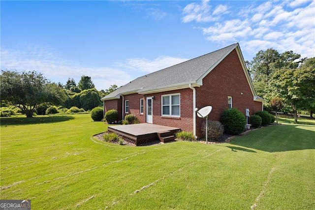 exterior space with a deck and a lawn