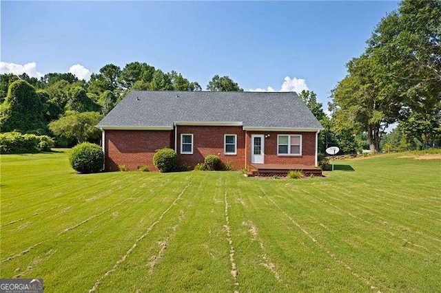 view of front facade with a deck and a front lawn