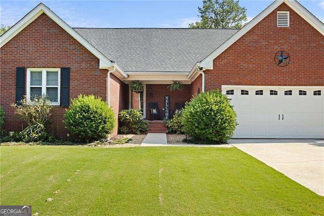 view of front of home featuring a garage and a front lawn