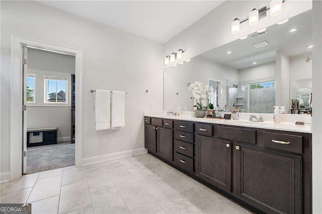 bathroom with vanity, tile patterned floors, and walk in shower