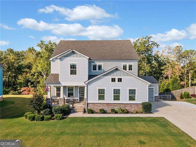 craftsman-style house featuring covered porch and a front lawn