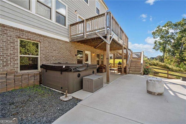 view of patio / terrace with a wooden deck and a hot tub