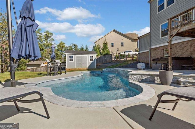 view of pool featuring a patio and a shed