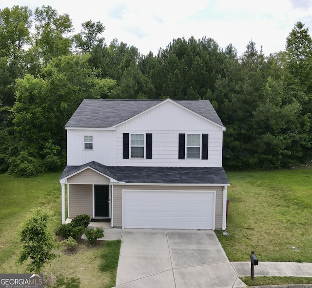 view of front of house with a garage and a front lawn