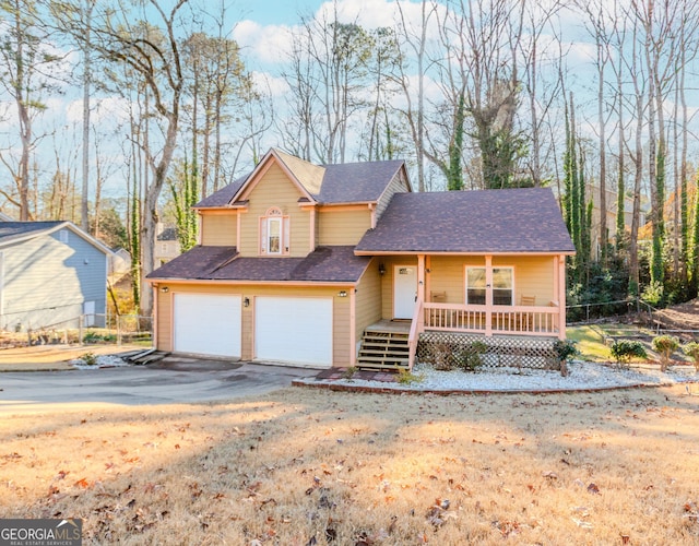 view of front property with a front yard, a porch, and a garage