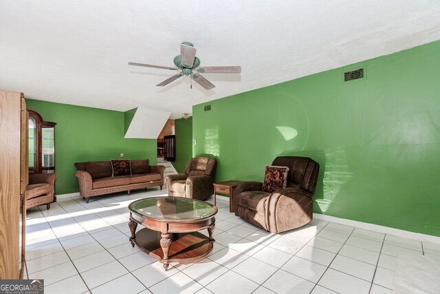 living room featuring light tile patterned floors and ceiling fan