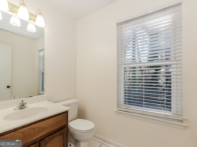 bathroom featuring tile patterned floors, vanity, and toilet