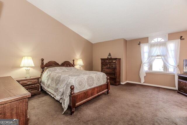 carpeted bedroom featuring lofted ceiling