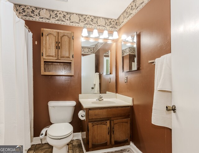 bathroom featuring vanity and toilet