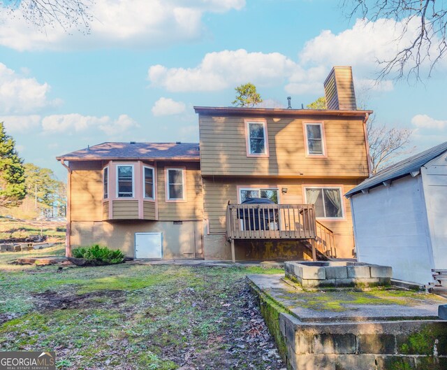 rear view of house with a wooden deck