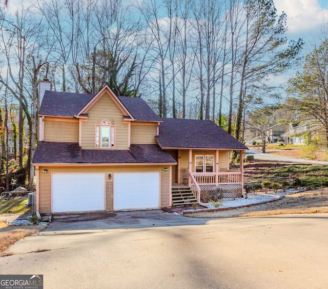 view of front of house featuring a porch and a garage