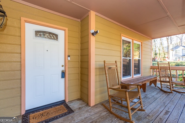 view of exterior entry with a porch