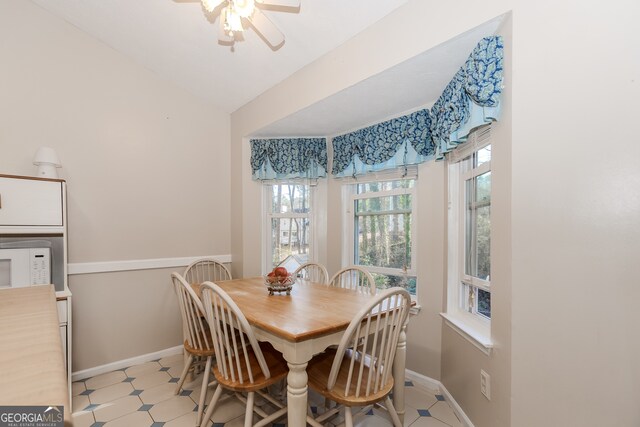 dining room featuring ceiling fan and lofted ceiling