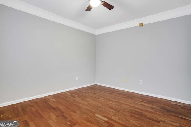 spare room with dark hardwood / wood-style flooring, ceiling fan, and crown molding