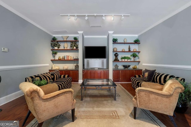 living room featuring hardwood / wood-style floors, track lighting, and ornamental molding