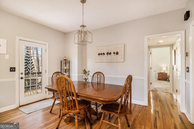 dining area featuring a notable chandelier and hardwood / wood-style floors