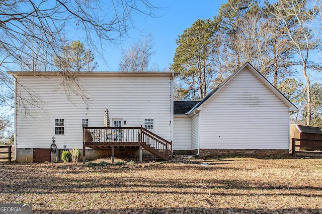 rear view of property featuring a deck