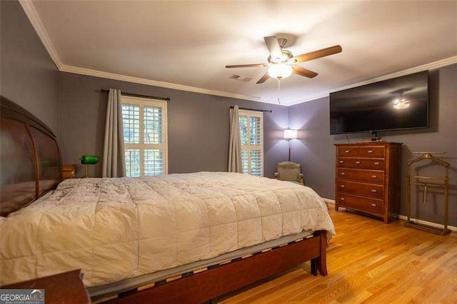 bedroom featuring crown molding, ceiling fan, and light hardwood / wood-style flooring