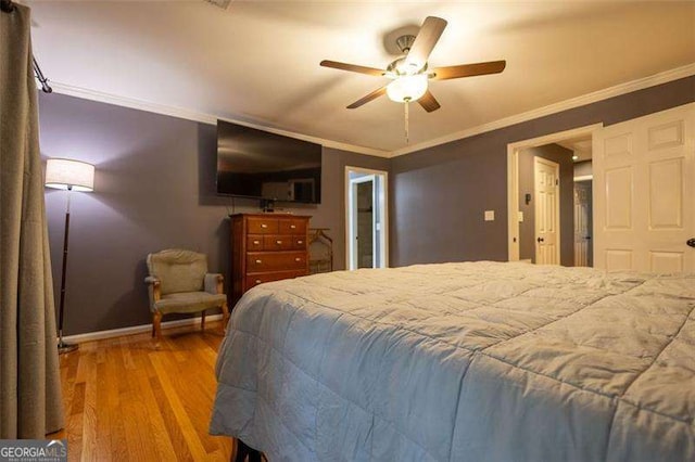 bedroom with crown molding, wood-type flooring, and ceiling fan