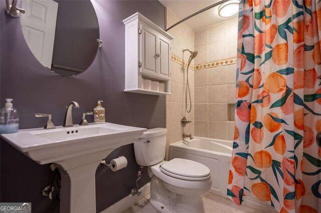 bathroom featuring shower / bath combo and toilet