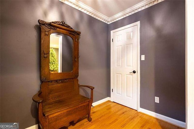 interior space featuring crown molding and hardwood / wood-style floors