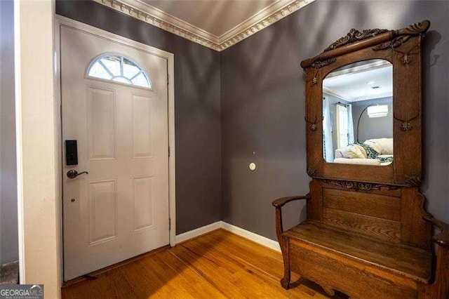 entrance foyer featuring crown molding and hardwood / wood-style floors