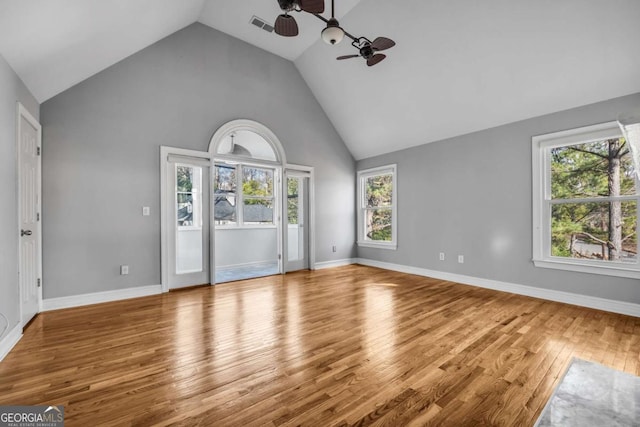 unfurnished living room with high vaulted ceiling, light hardwood / wood-style flooring, and ceiling fan