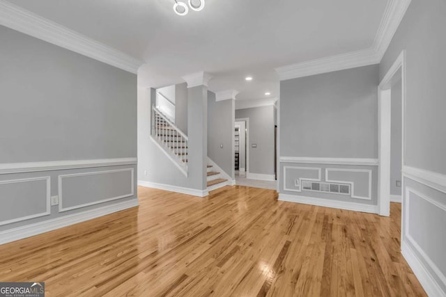 interior space with light wood-type flooring and crown molding