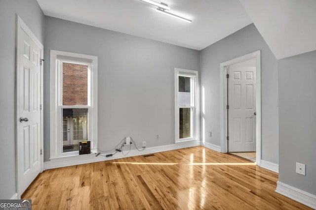 spare room with light hardwood / wood-style flooring