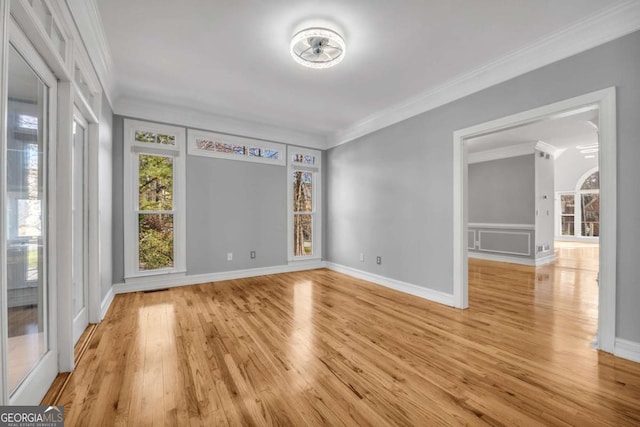 unfurnished room with ornamental molding and light hardwood / wood-style flooring