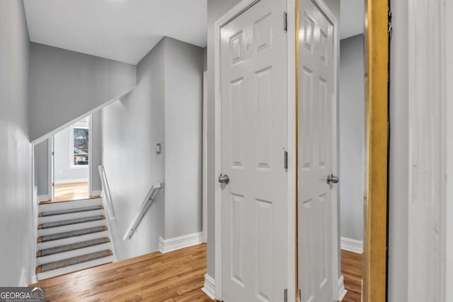 stairs with hardwood / wood-style flooring