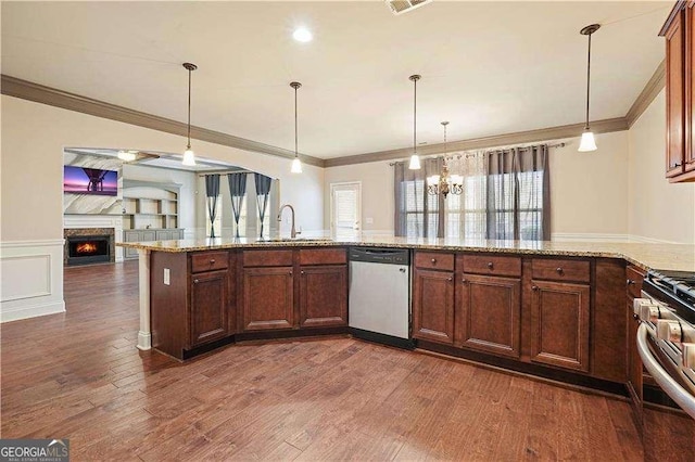 kitchen with dark wood-type flooring, hanging light fixtures, light stone countertops, appliances with stainless steel finishes, and a notable chandelier