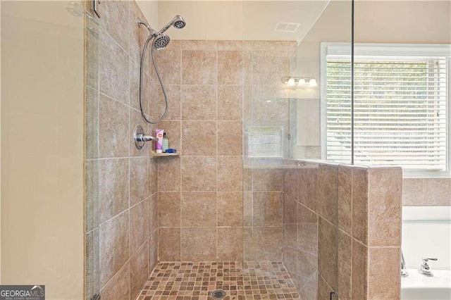 bathroom with tiled shower