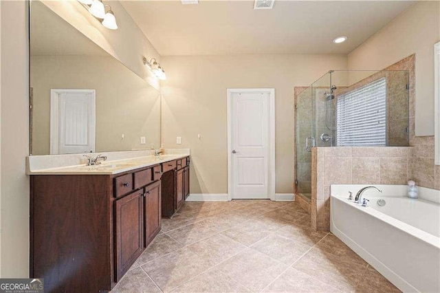 bathroom with tile patterned floors, plus walk in shower, and vanity