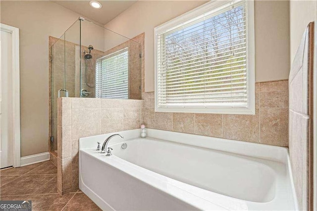 bathroom featuring tile patterned flooring and shower with separate bathtub