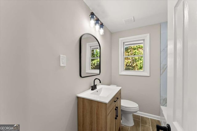 bathroom with vanity, toilet, and walk in shower