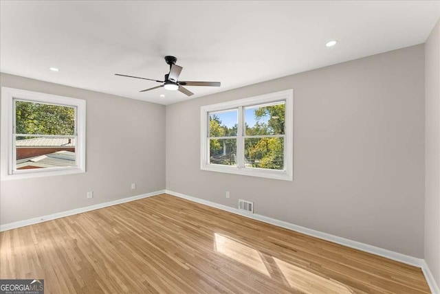 spare room featuring light hardwood / wood-style flooring and ceiling fan