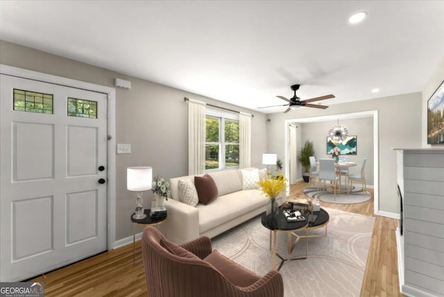 living room featuring light hardwood / wood-style floors and ceiling fan