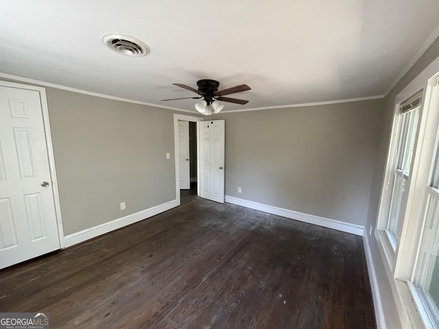 spare room with dark hardwood / wood-style floors, ceiling fan, and ornamental molding