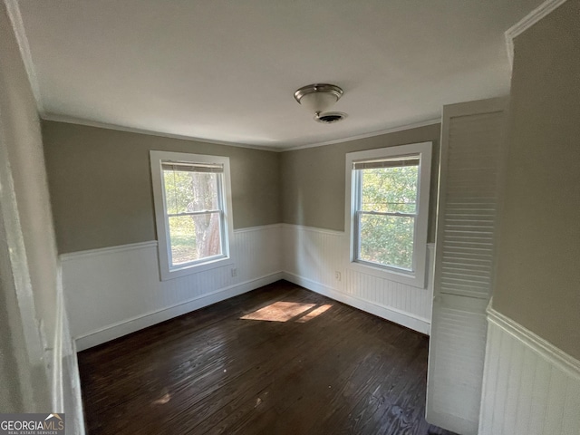 spare room featuring dark hardwood / wood-style flooring and ornamental molding